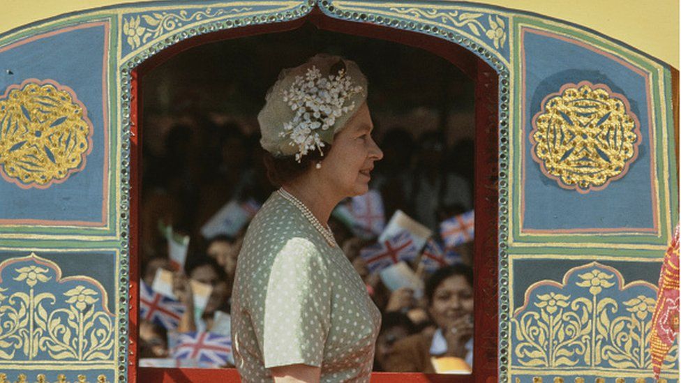 British Royal Queen Elizabeth II wearing a pale green dress with white polka dots, and a matching pale green hat, at the Raj Ghat Mahatma Gandhi Memorial in Delhi during a nine-day State Visit to India, 17th November 1983. (Photo by Tim Graham Photo Library via Getty Images)